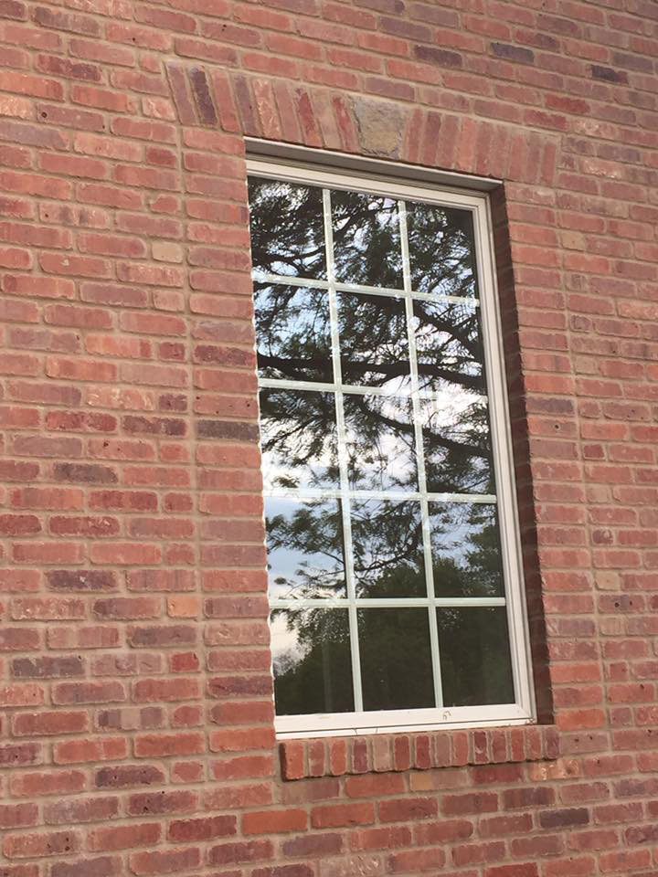 replaced brick around a window in a building